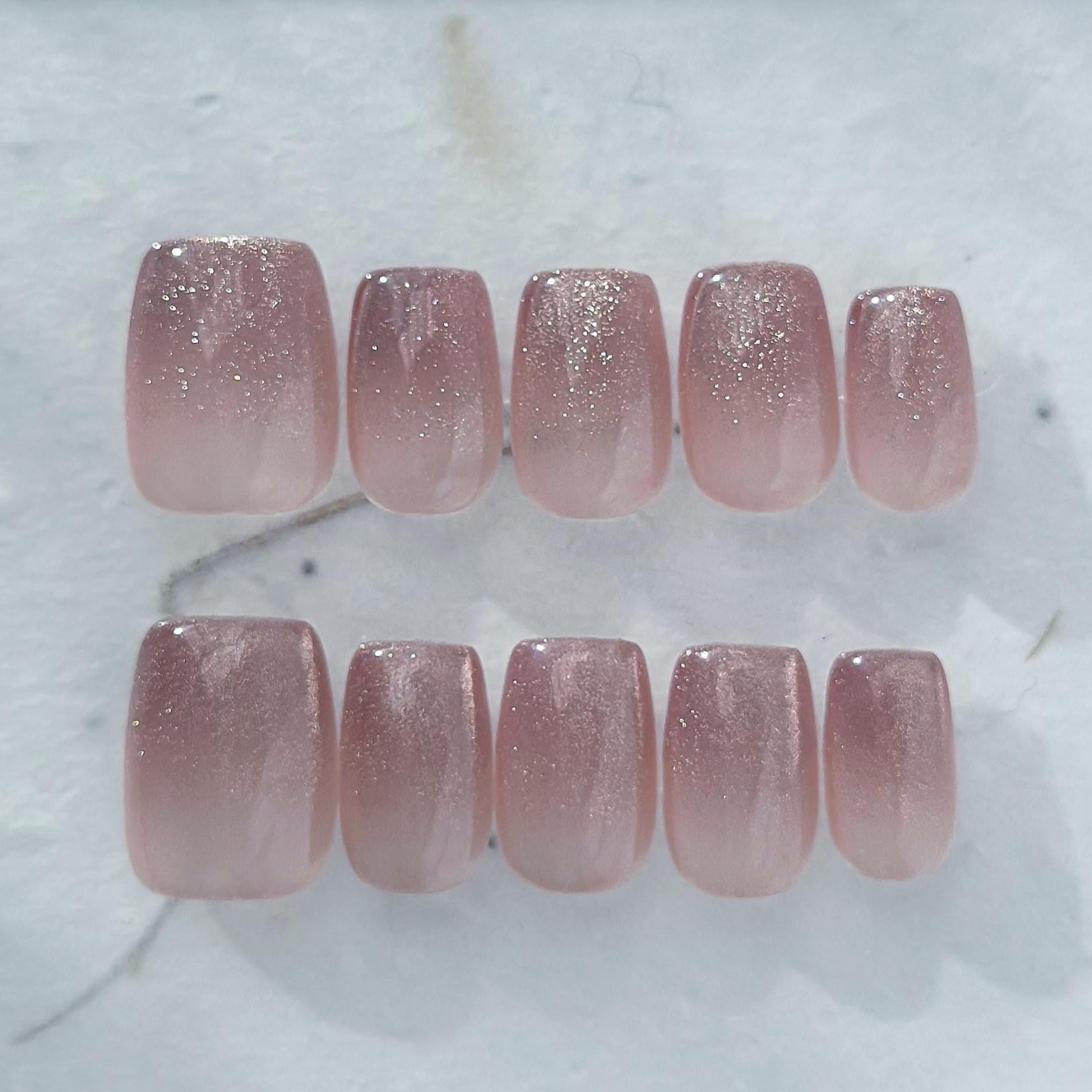 Short square pink mauve ombré press-on nails with fine glitter shimmer, soft blush gradient, and glossy finish