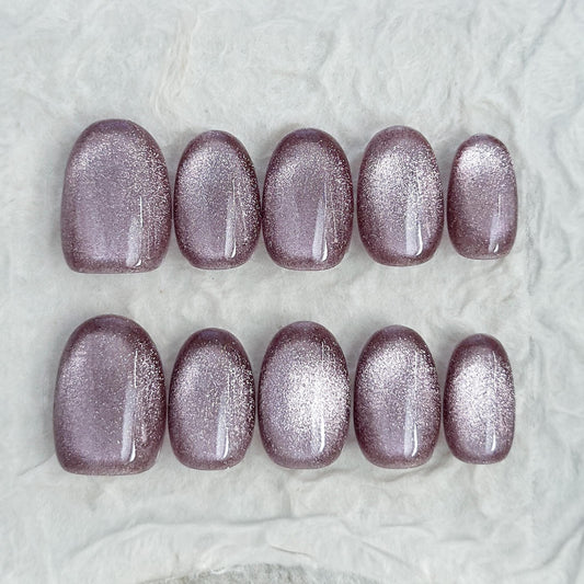Short oval press-on nails in a metallic mauve cat-eye shimmer, glossy finish, luxury reusable press-on manicure by ManiFleur