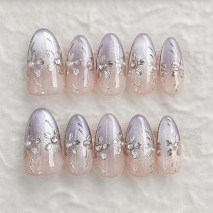 press on nails in light purple and nude ombre base with gold floral accents 