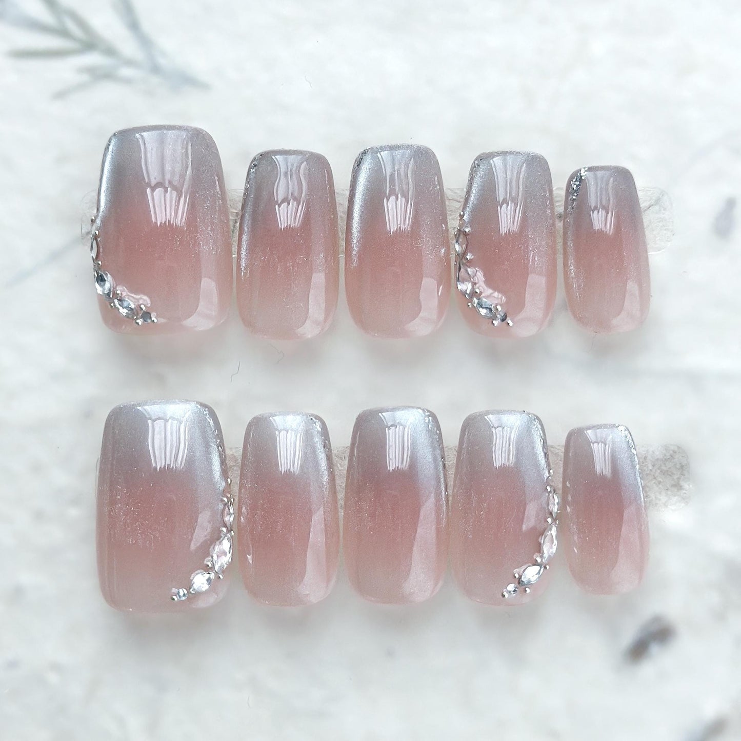 Square shape pink ombré press-on nails with silver cat-eye shimmer and rhinestone accents