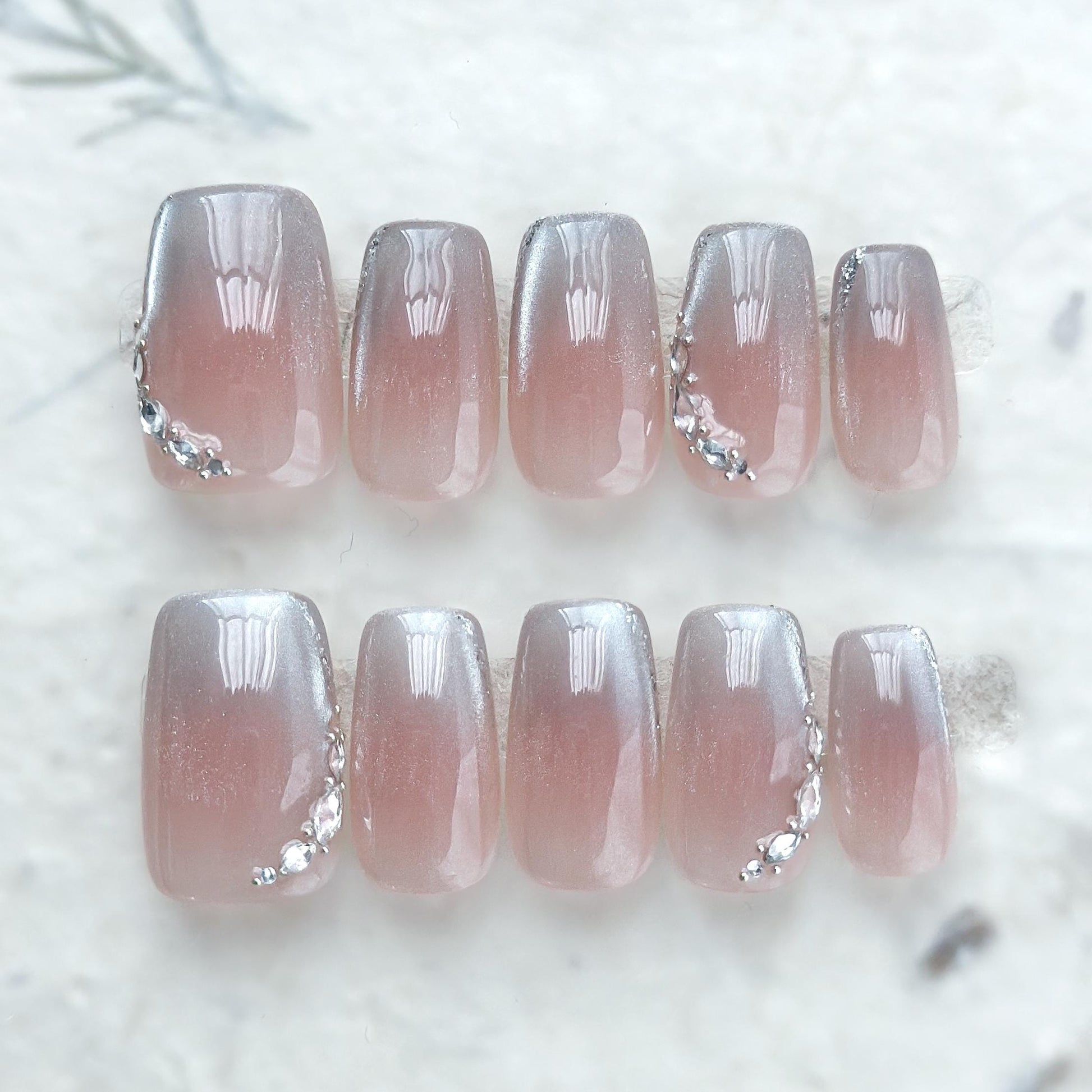 Square shape pink ombré press-on nails with silver cat-eye shimmer and rhinestone accents
